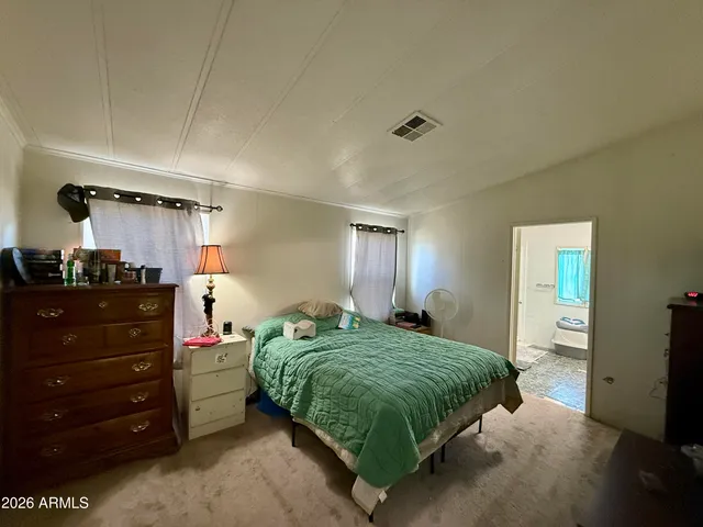 a bedroom with a bed and a mirror