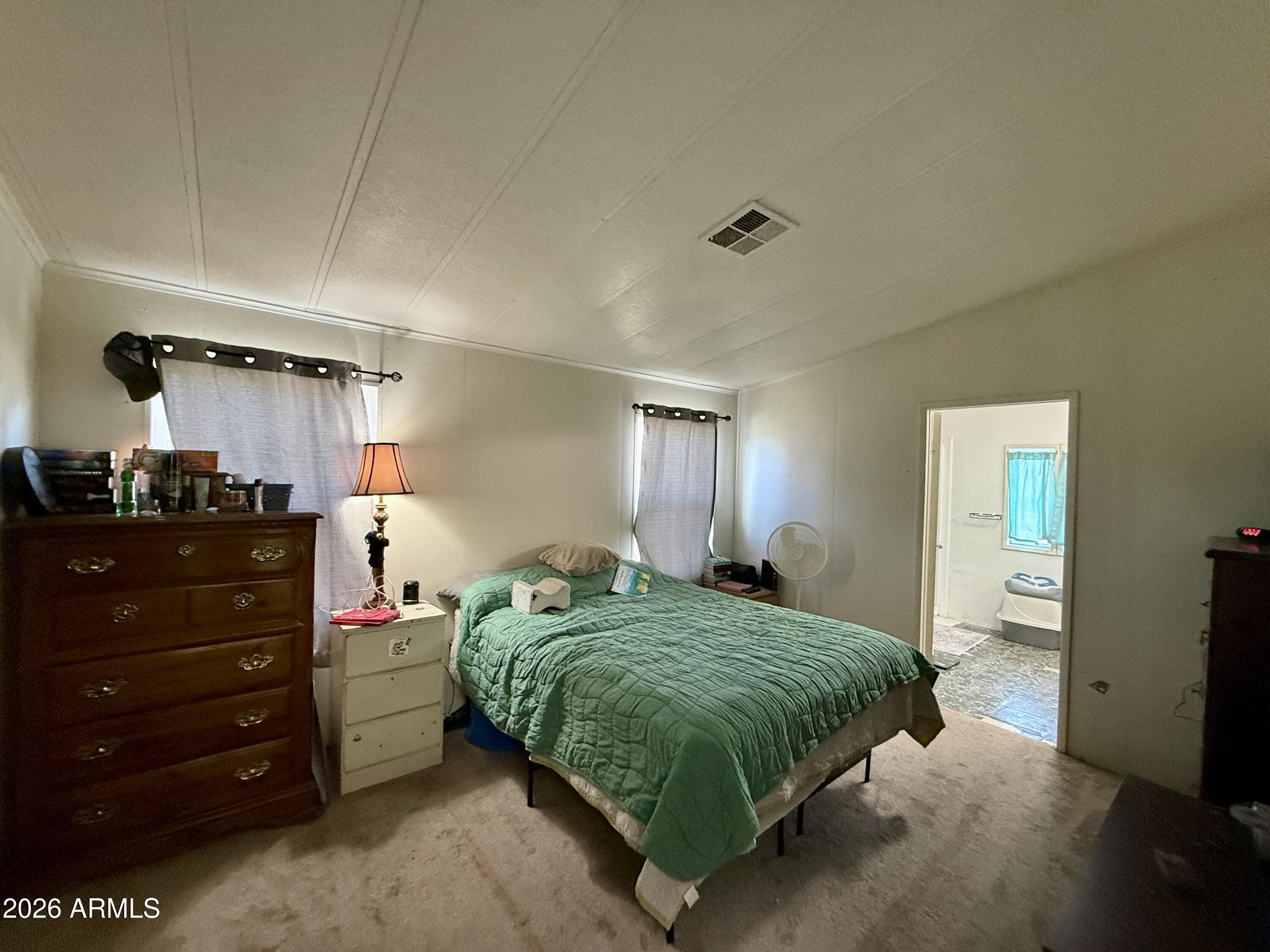 28 East 300th Pima, AZ 85543 - Photo 7 of 20 a bedroom with a bed and a mirror