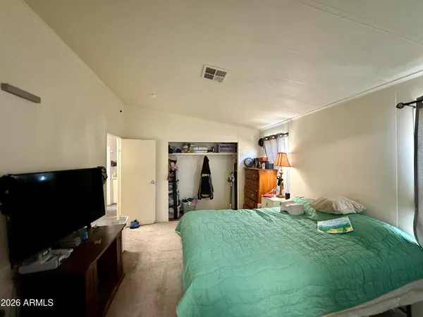 a bed room with a bed and a television