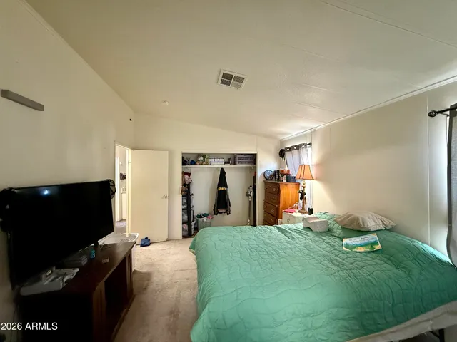 a bed room with a bed and a television