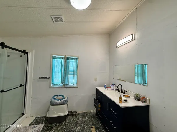 a bathroom with a sink toilet and mirror