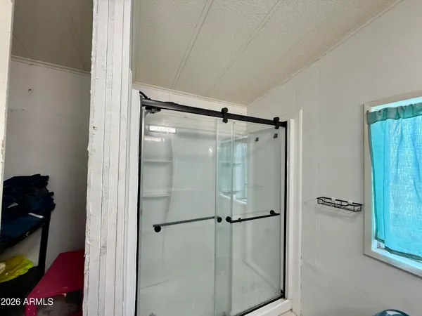 a bathroom with a glass shower door