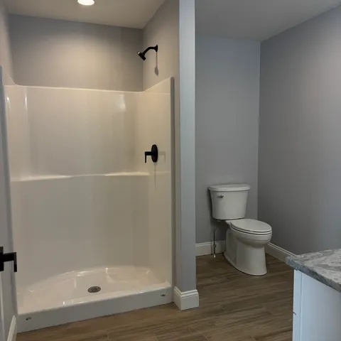 a bathroom with a granite countertop toilet a sink and bathtub