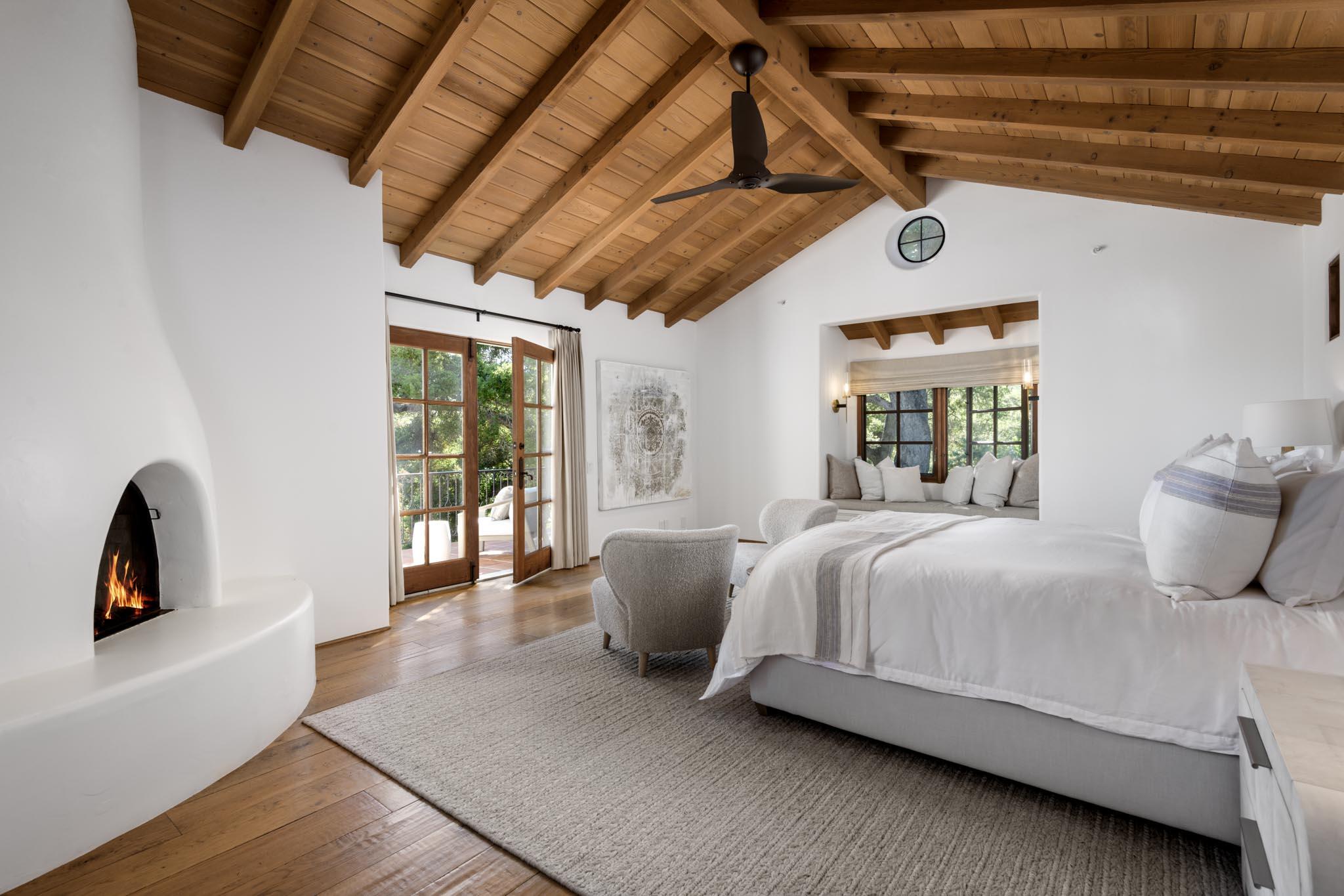 849 Ashley Road Montecito, CA 93108 - Photo 14 of 28 a bedroom with a bed a couch and large window with wooden floor