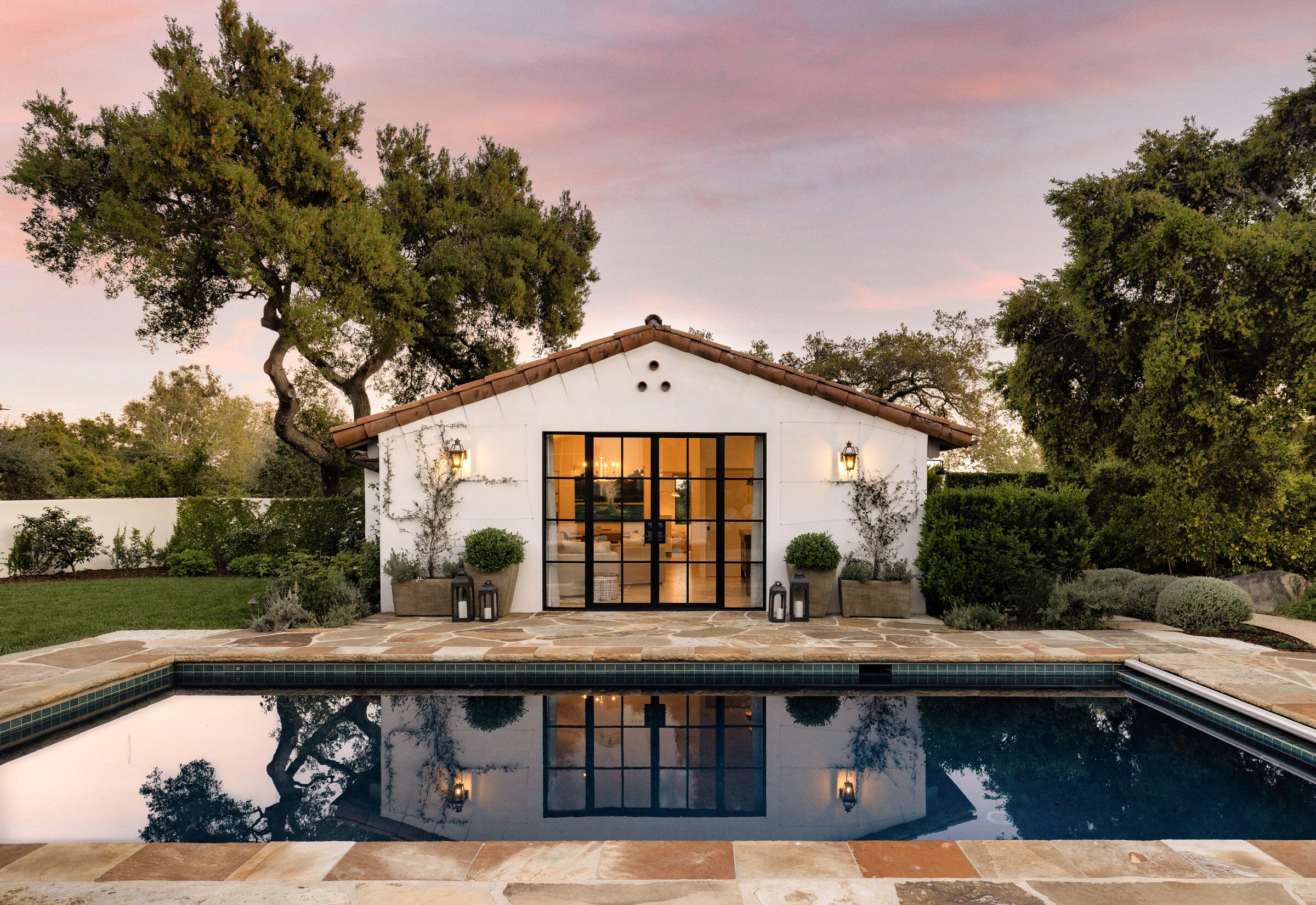 849 Ashley Road Montecito, CA 93108 - Photo 3 of 28 a view of a house with a swimming pool and a chairs in patio