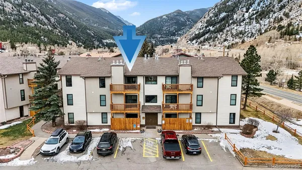 a building outdoor space with patio furniture and potted plants