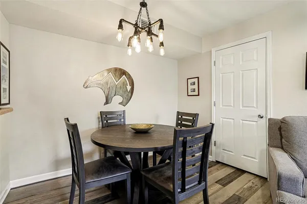 a view of a dining room with furniture and chandelier