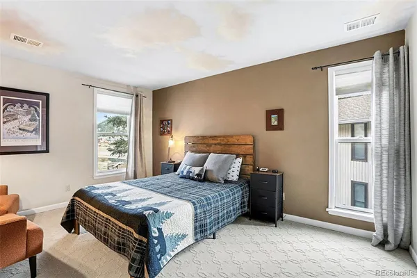 a bedroom with a large bed and a window