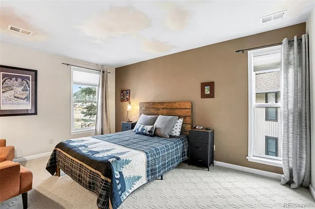 a bedroom with a large bed and a window