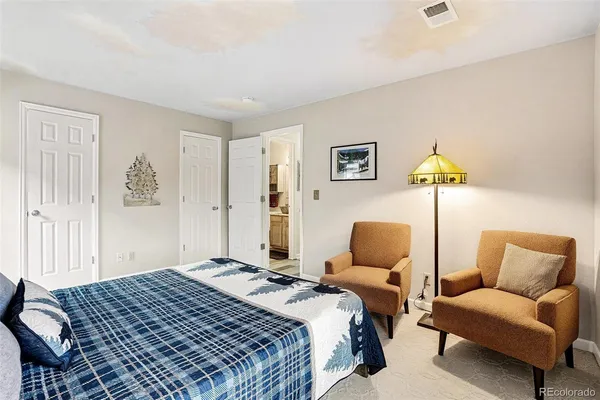 a bedroom with a bed and chair