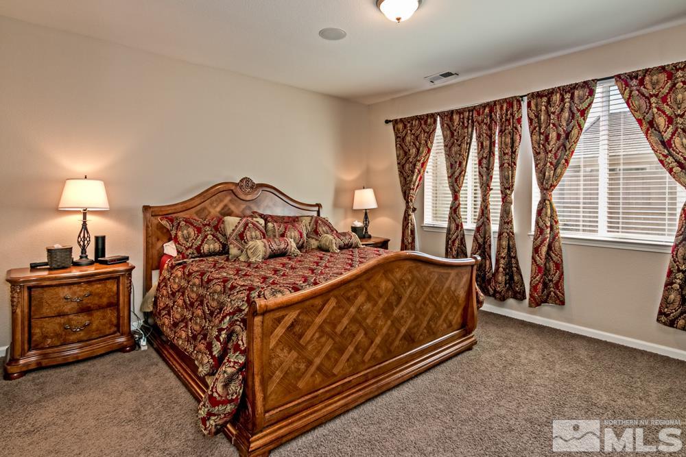 10755 Cedar Rock Drive Reno, NV 89521 - Photo 11 of 22 a bed sitting in a bedroom next to a window