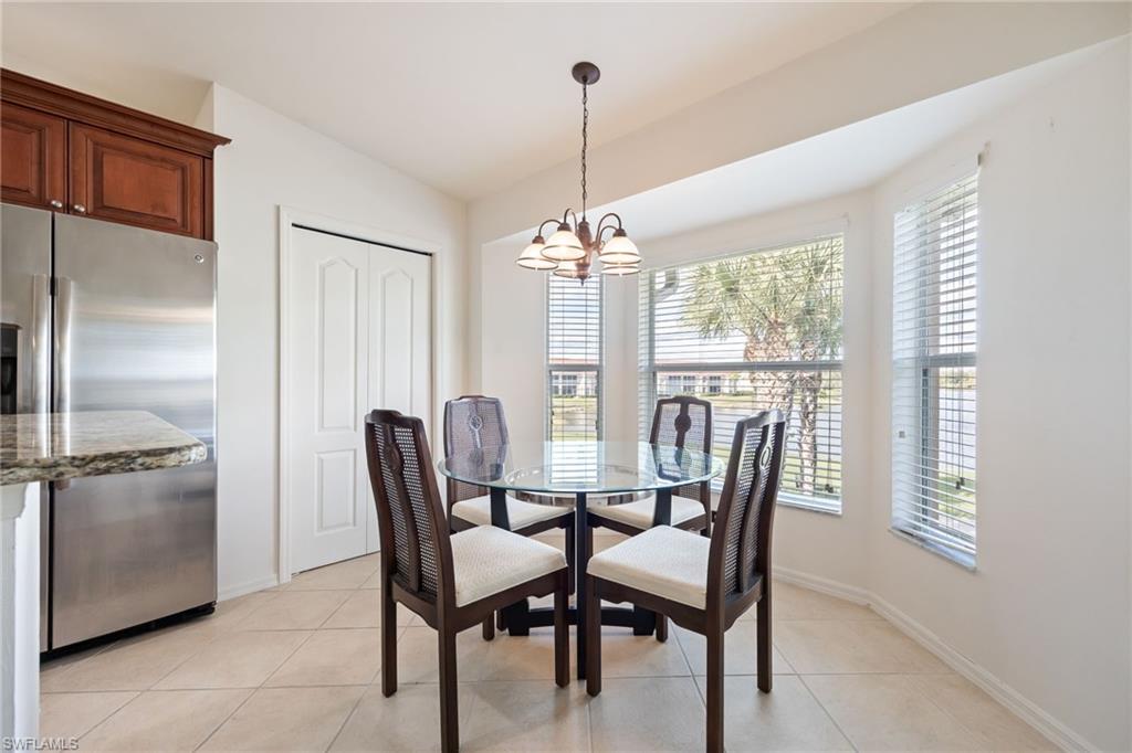 2770 Cypress Trace Circle, Unit 2425 Naples, FL 34119 - Photo 12 of 35 a view of a dining room with furniture window and outside view