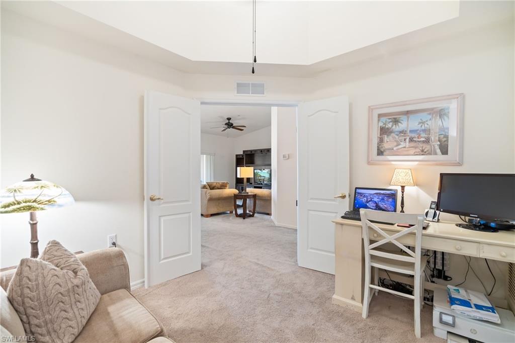 2770 Cypress Trace Circle, Unit 2425 Naples, FL 34119 - Photo 22 of 35 a view of a livingroom with furniture and a flat screen tv