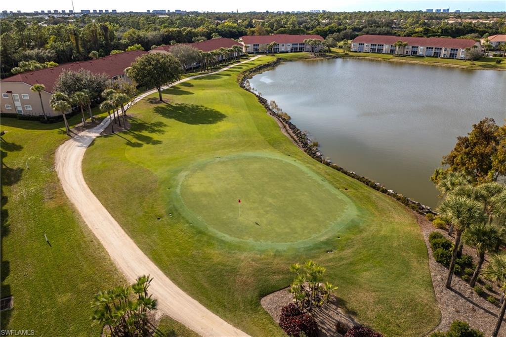 2770 Cypress Trace Circle, Unit 2425 Naples, FL 34119 - Photo 25 of 35 a view of a swimming pool with a lake