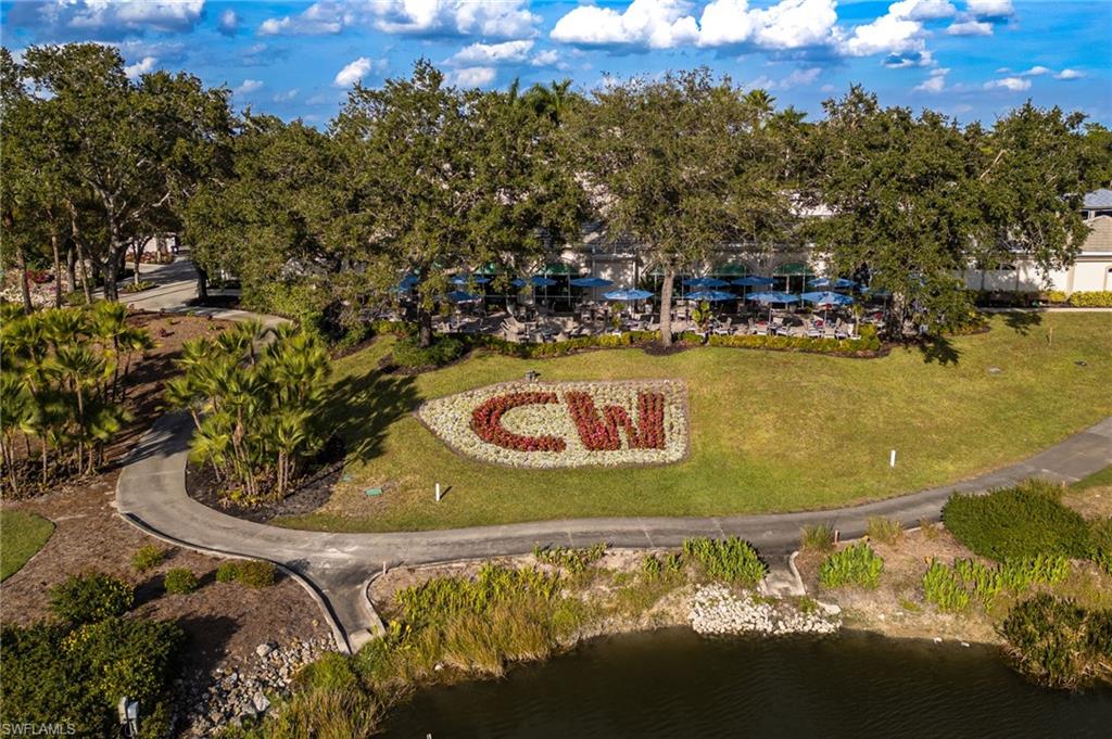 2770 Cypress Trace Circle, Unit 2425 Naples, FL 34119 - Photo 32 of 35 a view of a swimming pool with a yard and mountain view