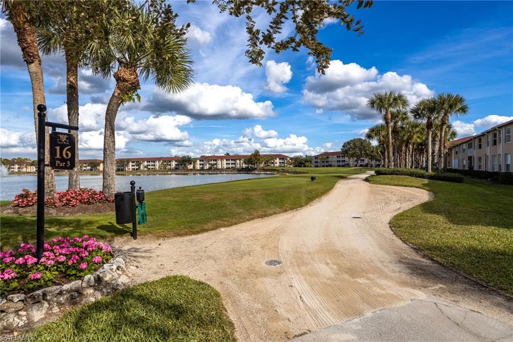 2770 Cypress Trace Circle, Unit 2425 Naples, FL 34119 - Photo 33 of 35 a view of a lake with a house in the background