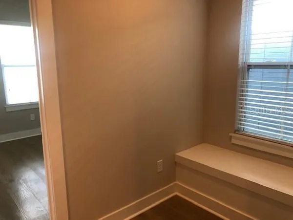 an empty room with wooden floor and closet