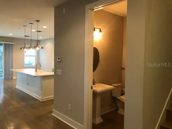 a bathroom with a sink a mirror and a toilet