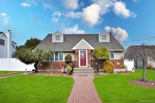 a view of a house with a yard and sitting area