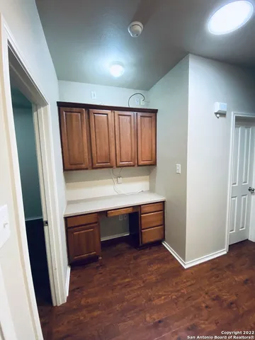 a view of room with cabinets and wooden floor