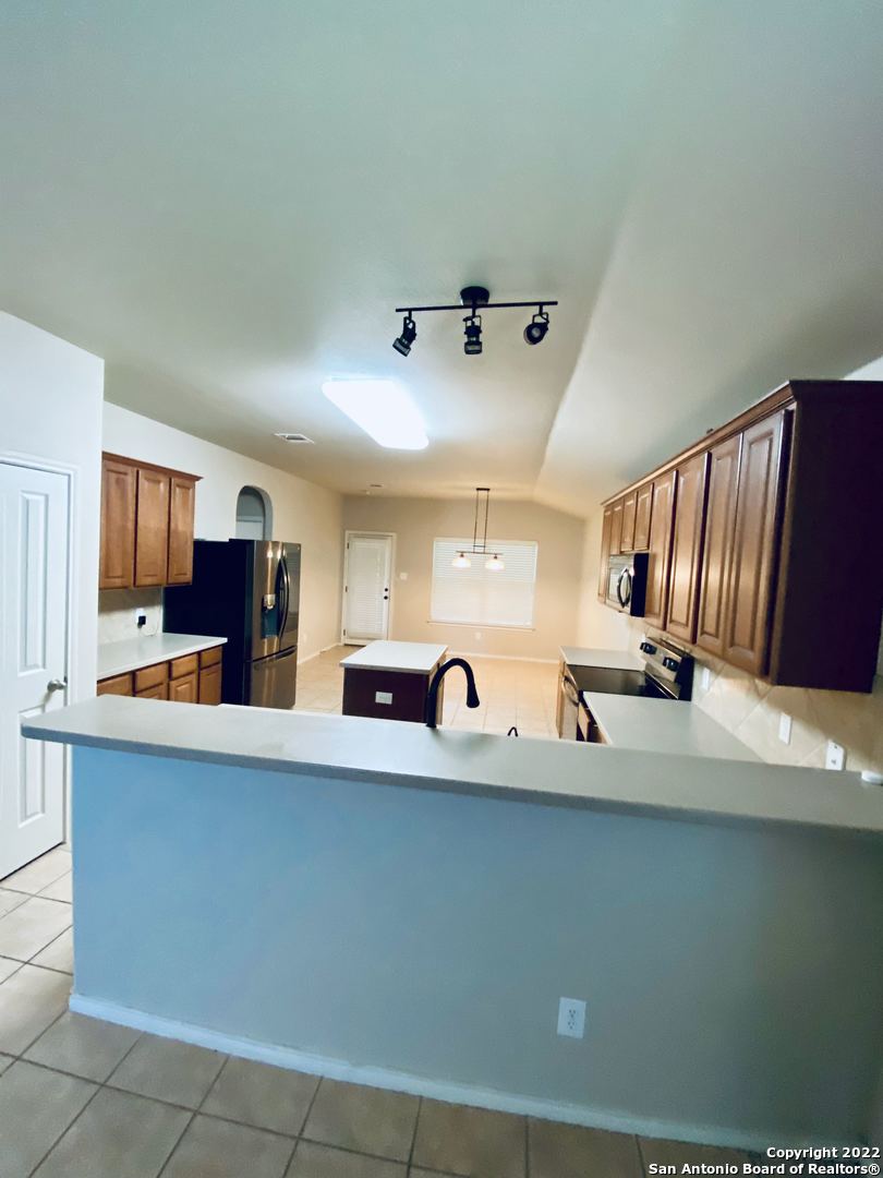 707 Point Sunset San Antonio, TX 78253 - Photo 4 of 15 a kitchen with stainless steel appliances a sink a stove and a refrigerator