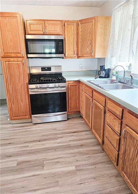 117 Little Rock Road Kittanning, PA 16201 - Photo 8 of 23 a kitchen with stainless steel appliances a stove and a sink