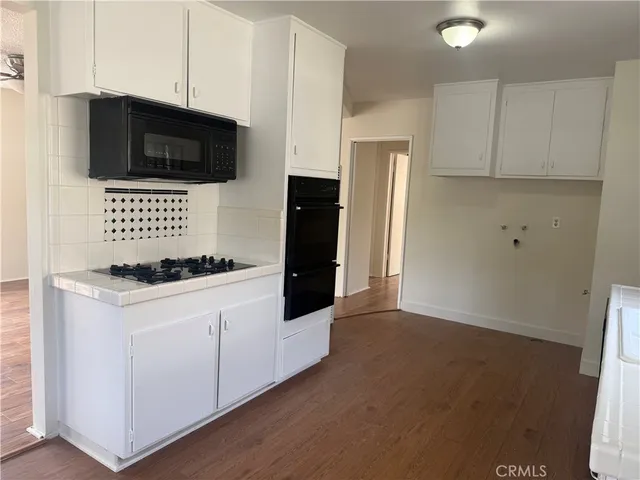a kitchen with stainless steel appliances a stove microwave and refrigerator