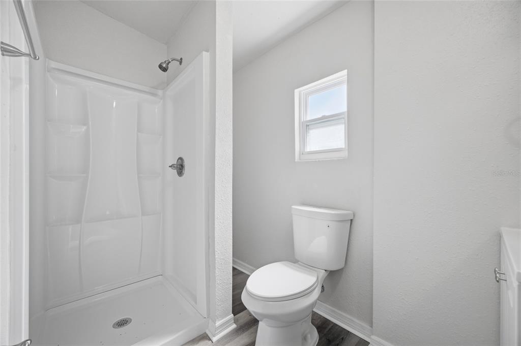 6629 Sierra Terrace New Port Richey, FL 34652 - Photo 10 of 30 a bathroom with a toilet and a shower
