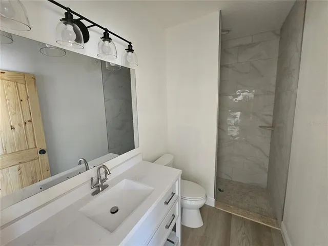 a bathroom with a glass shower door