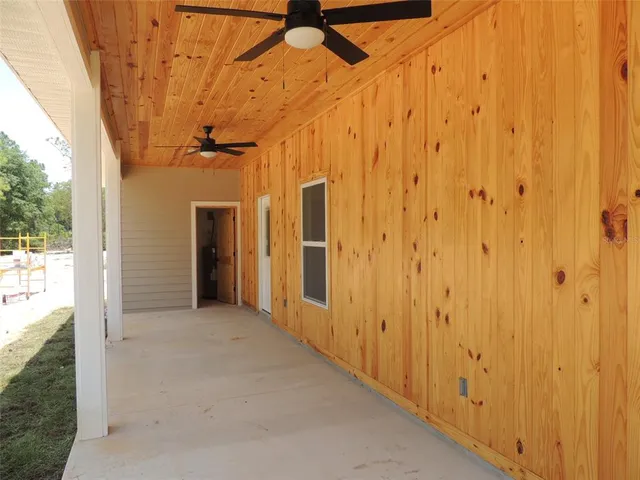 a view of a hallway with wooden walls