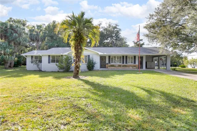 a front view of a house with swimming pool and porch