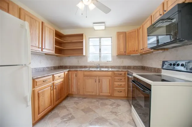 a kitchen with stainless steel appliances granite countertop a sink and cabinets
