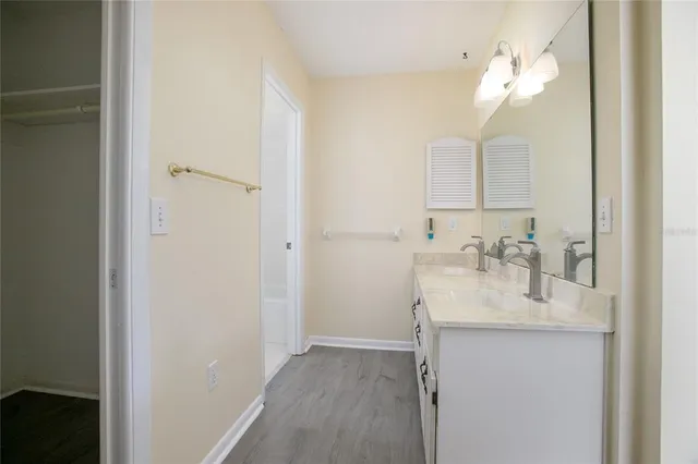 a bathroom with a sink vanity granite and a mirror