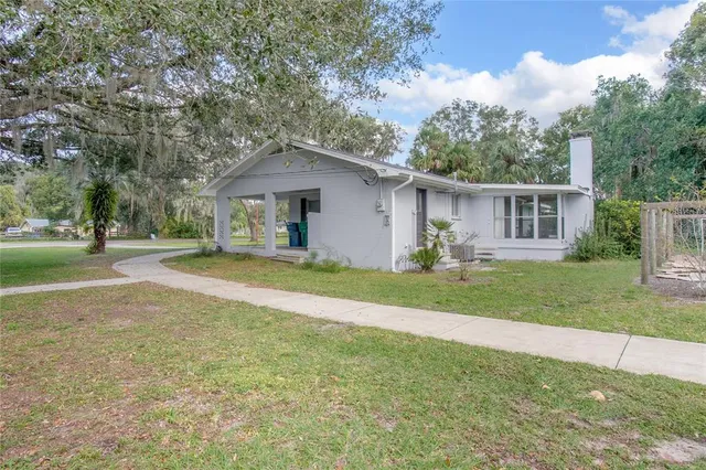 a front view of house with yard and green space