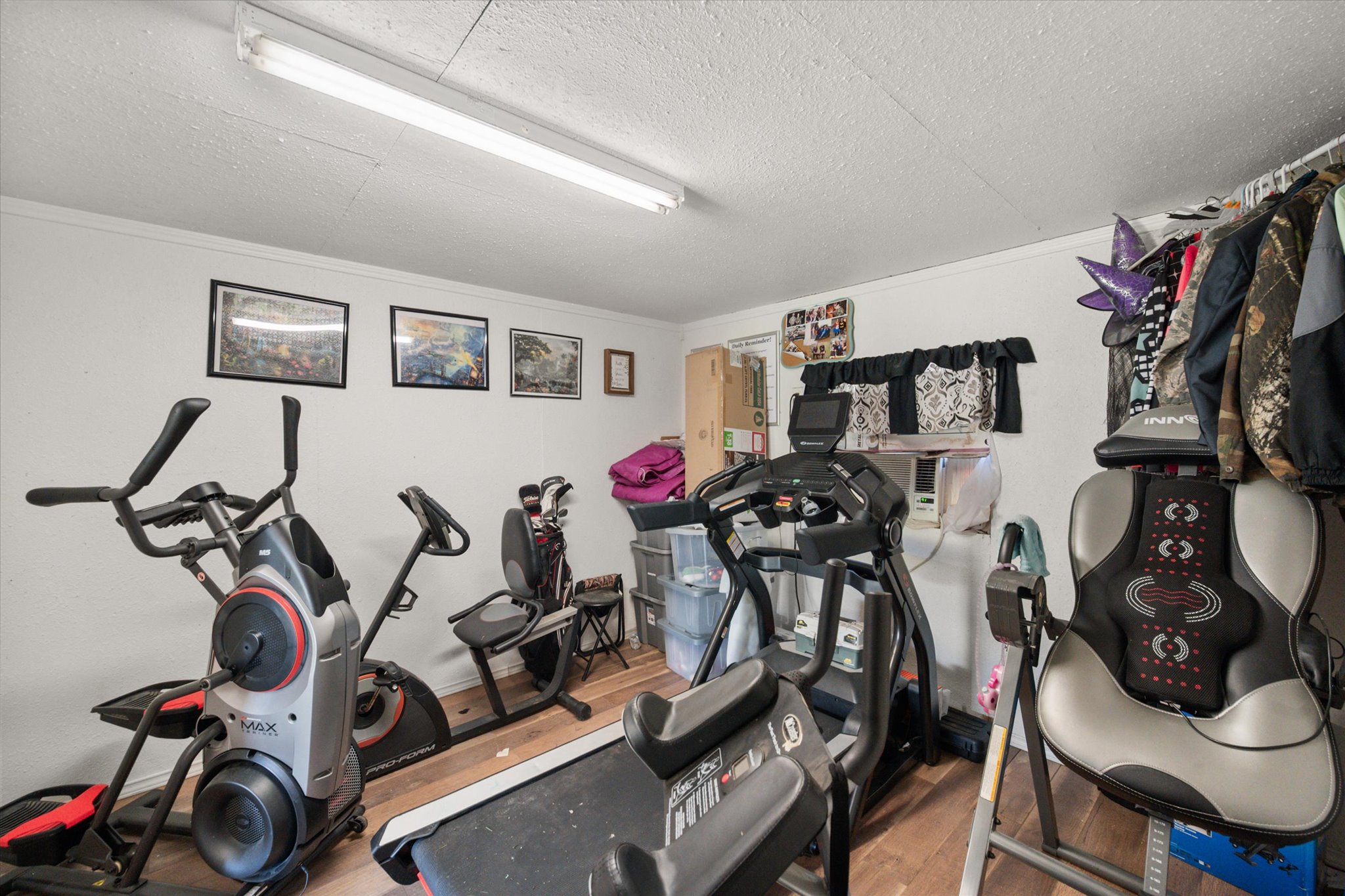 16857 Fm 639 Road East Purdon, TX 76679 - Photo 7 of 38 Exercise area featuring a textured ceiling and wood finished floors