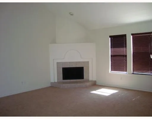 a view of empty room with a fireplace