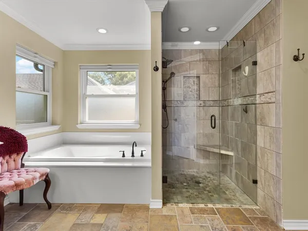 a bathroom with a bathtub and a shower