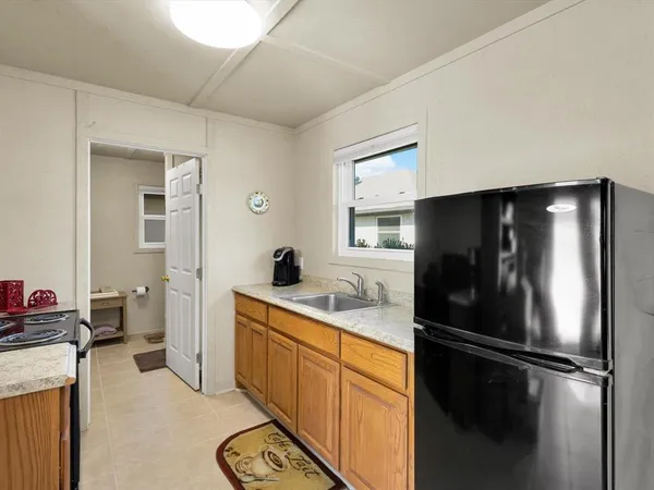 a kitchen with a refrigerator and a sink