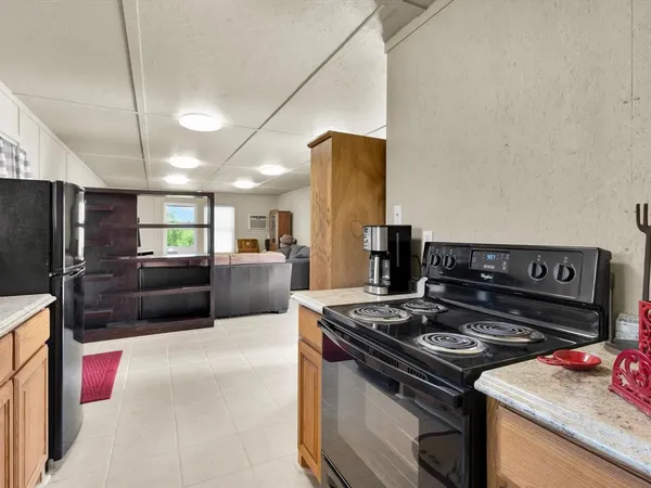 a kitchen with a stove and a refrigerator