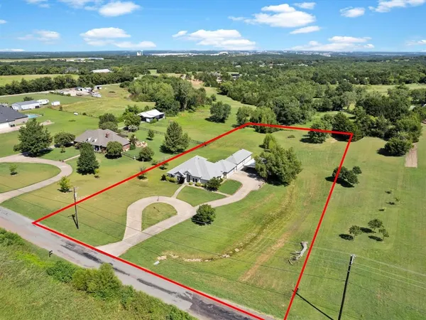 an aerial view of a residential houses with outdoor space