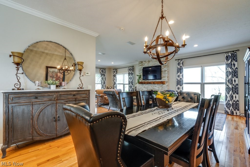 6325 Brecksville Road Independence, OH 44131 - Photo 14 of 50 Dining area featuring hardwood floors, a large decorative mirror, and a chandelier