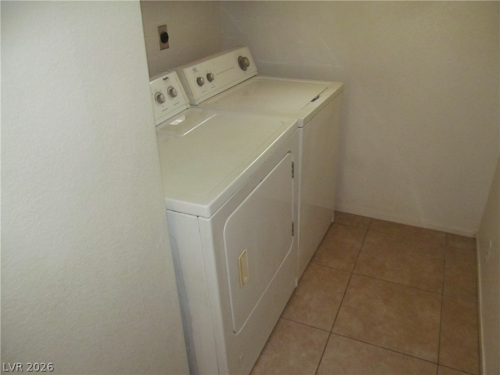 8701 Crescent Ridge Lane Las Vegas, NV 89134 - Photo 15 of 28 Functional laundry nook with tiled flooring, ready for everyday convenience.