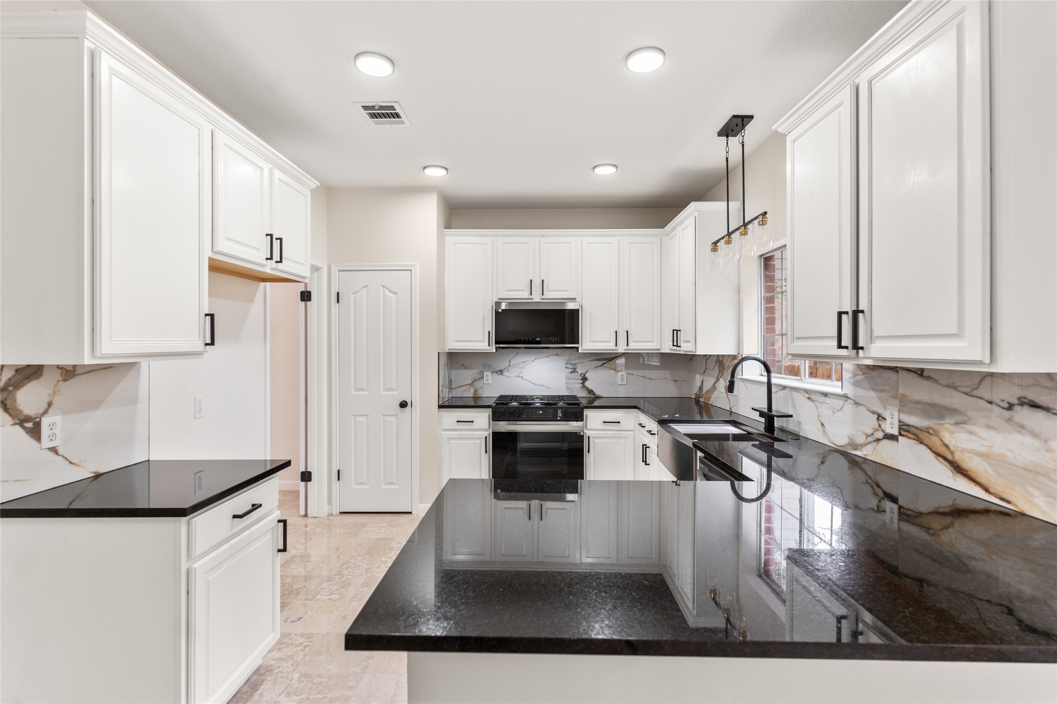 13102 Hunters Chase Drive Austin, TX 78729 - Photo 11 of 39 a kitchen with stainless steel appliances granite countertop a stove a sink and a refrigerator