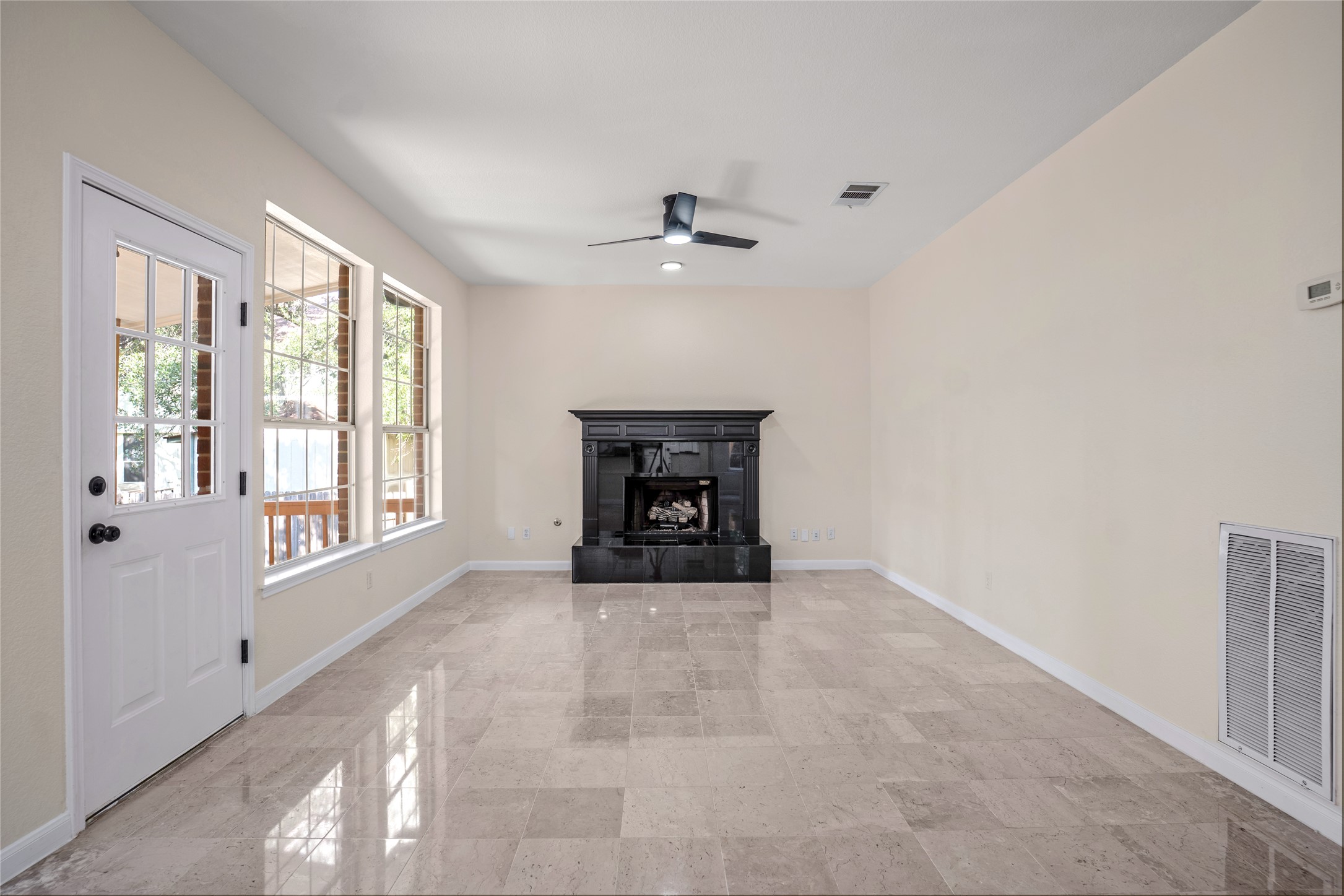 13102 Hunters Chase Drive Austin, TX 78729 - Photo 13 of 39 an empty room with windows and fireplace
