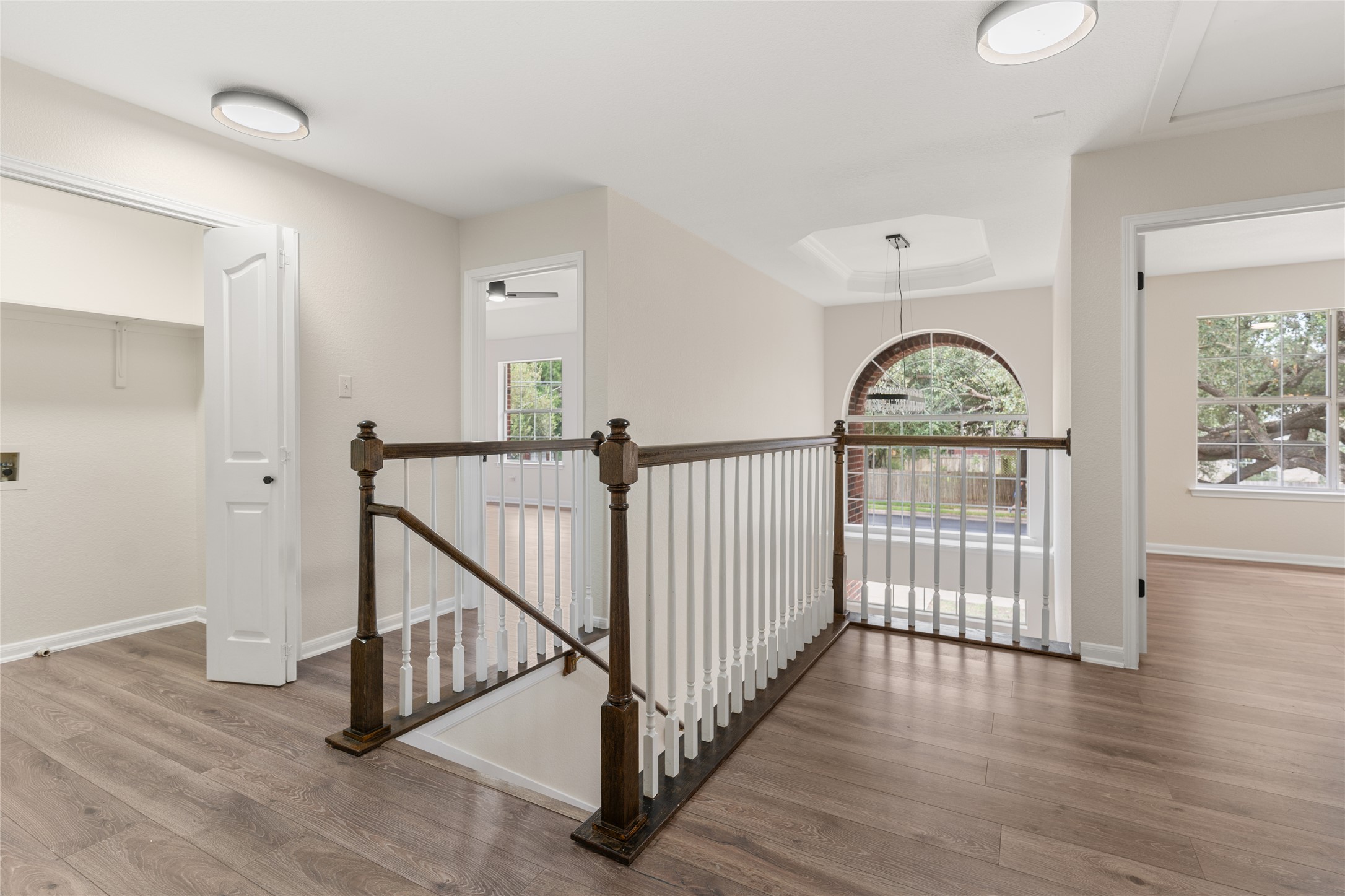 13102 Hunters Chase Drive Austin, TX 78729 - Photo 18 of 39 a view of staircase with wooden floor and windows