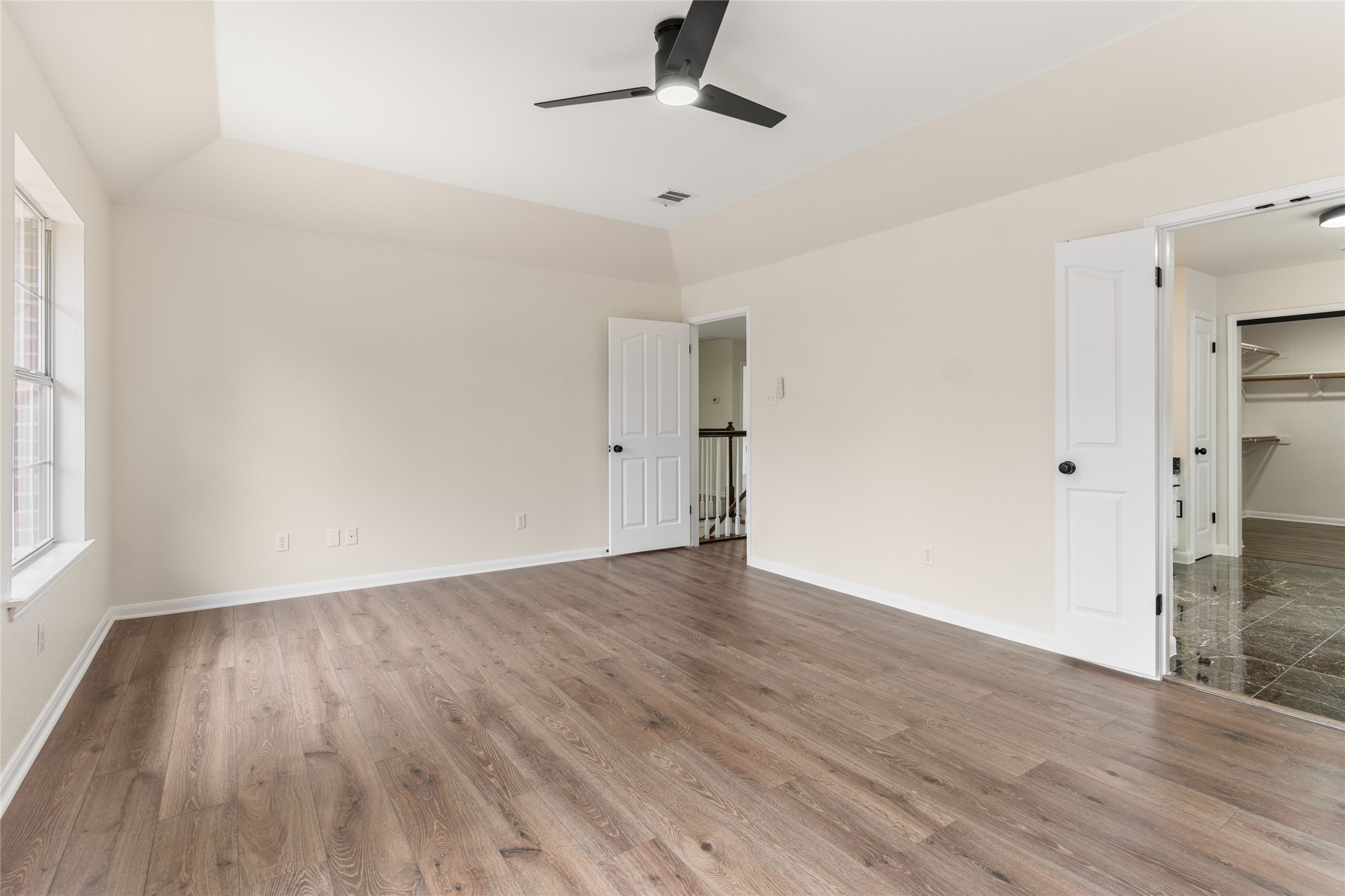 13102 Hunters Chase Drive Austin, TX 78729 - Photo 27 of 39 a view of an empty room with wooden floor and a window