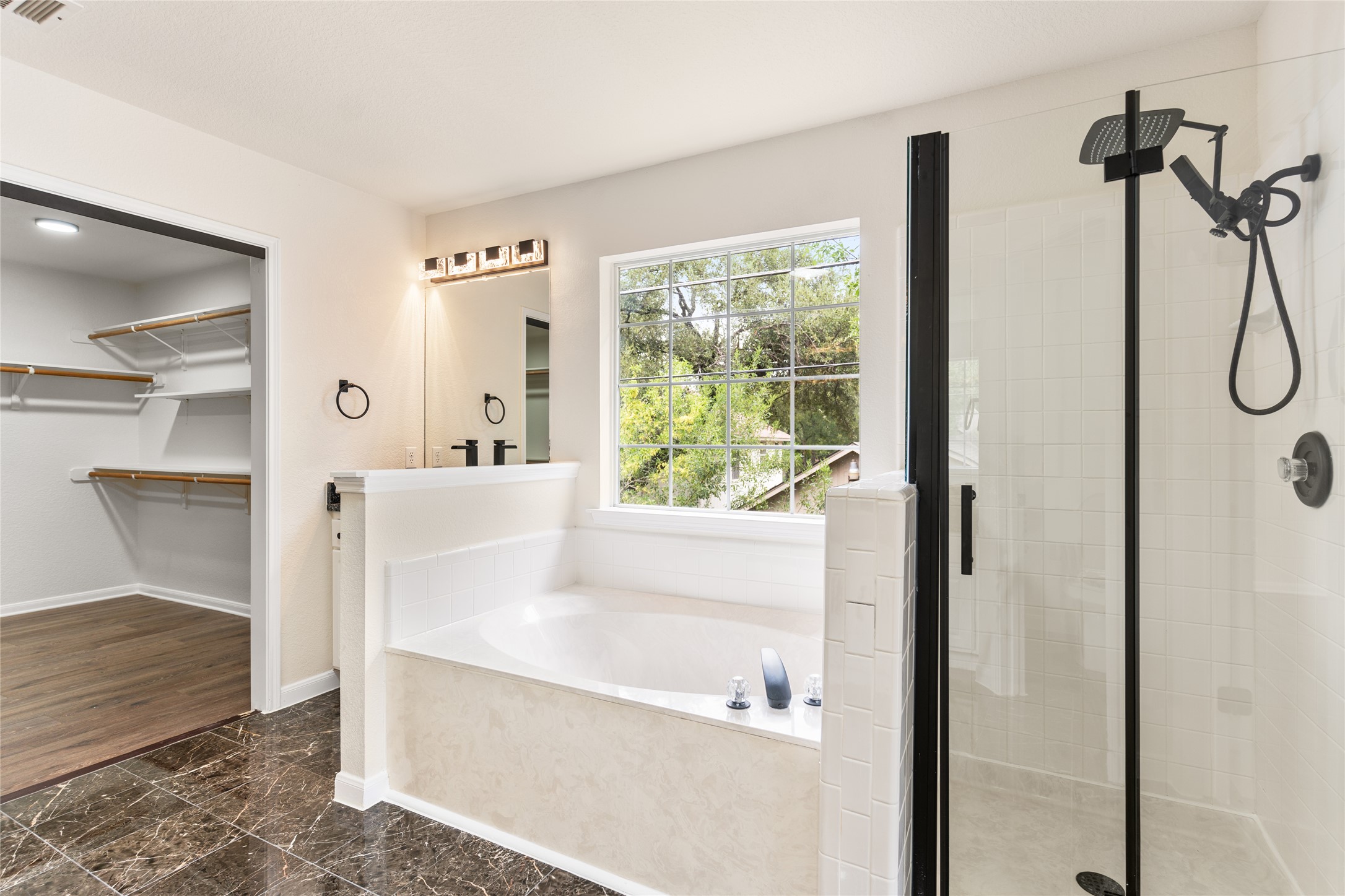 13102 Hunters Chase Drive Austin, TX 78729 - Photo 29 of 39 a bathroom with a bathtub and a shower