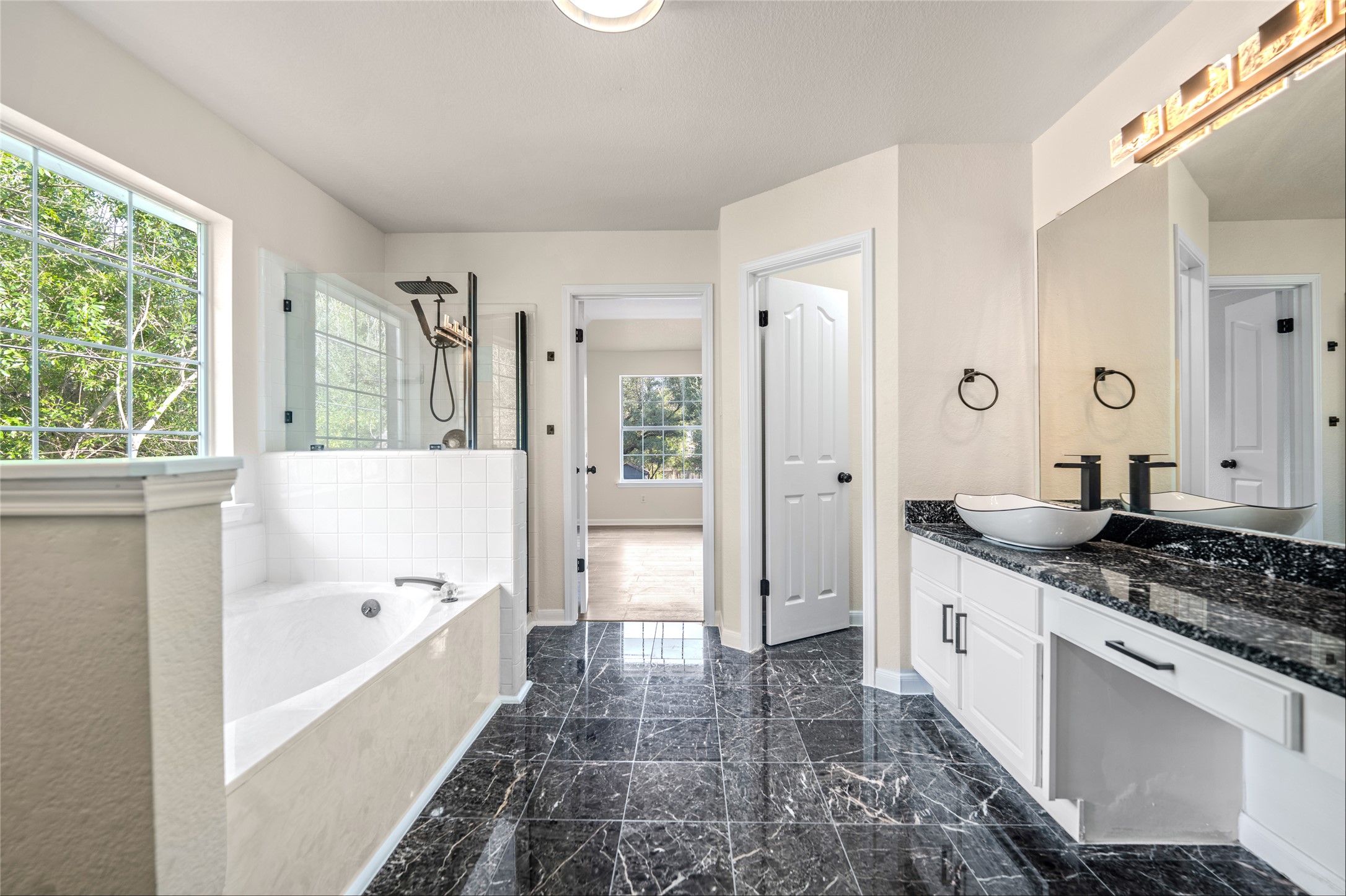 13102 Hunters Chase Drive Austin, TX 78729 - Photo 33 of 39 a bathroom with a granite countertop tub sink and mirror