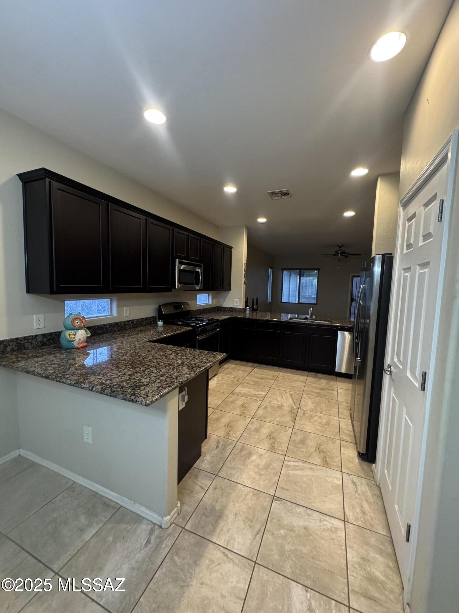 8697 West Denstone Road Marana, AZ 85653 - Photo 11 of 21 More counter space going into the dining room.