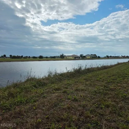 a view of a lake with houses in the back
